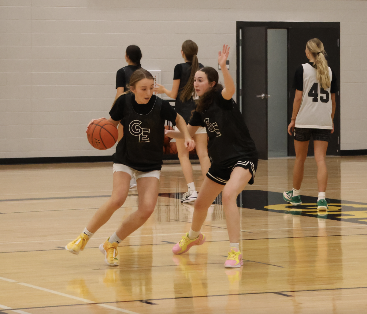 During practice, junior Kate Rhoades tries to drive past junior Taryn French during the one versus one drill.